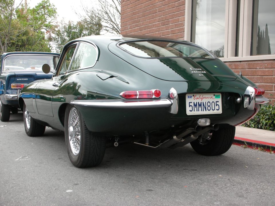 Dark green Jaguar E-Type coupe rear three-quarter with California plate 5MMN805