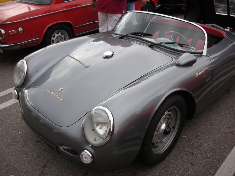 1998 Ford Crown Victoria - gray Porsche 550 Spyder-style roadster with red interior parked beside a red coupe at an outdoor show.