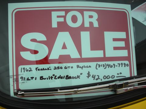 1998 Ford Crown Victoria - Handwritten FOR SALE windshield sign for a 1962 Ferrari 250 GTO replica with price and phone number.