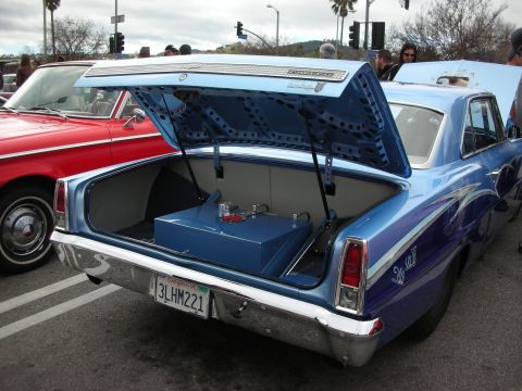 1998 Ford Crown Victoria - blue custom car with its trunk lid raised on a louvered support, showing a polished fuel cell inside the trunk.