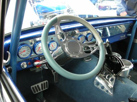 1998 Ford Crown Victoria - custom car interior with a blue metal dash, white-rimmed steering wheel, white-faced gauges and a chrome pedal.