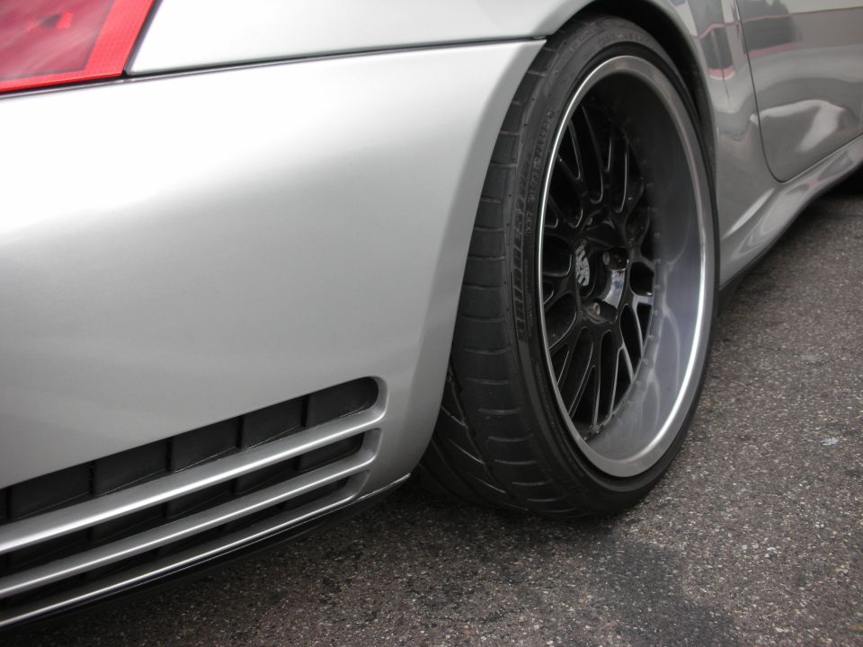 Close-up of a silver Porsche rear quarter and black multi-spoke wheel