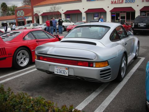 1998 Ford Crown Victoria - silver Porsche 959 shown from the rear with a California plate, parked next to a red Ferrari F40 outside Nails 2000.