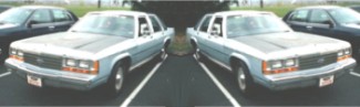 1989 Ford LTD Crown Victoria - A mirrored/duplicated image showing a two-tone white-over-gray Ford full-size sedan photographed from a front three-quarter angle, parked o…