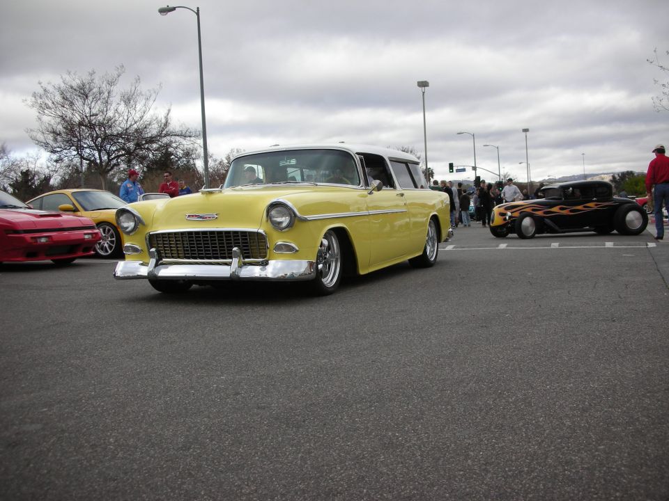 Yellow 1955 Chevrolet Nomad custom wagon at outdoor car show