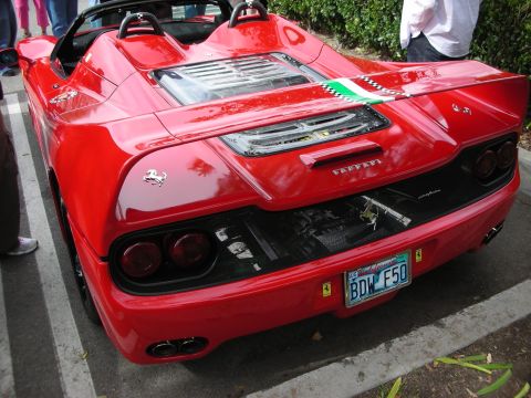 1998 Ford Crown Victoria - Rear view of a red Ferrari F50 showing its exposed engine, taillights, and a license plate reading BDW F50.