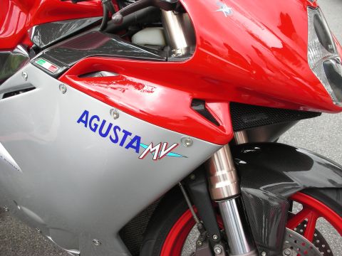 1998 Ford Crown Victoria - Close-up of a red-and-silver MV Agusta F4 showing the Agusta MV decal, gold forks, and red front wheel.