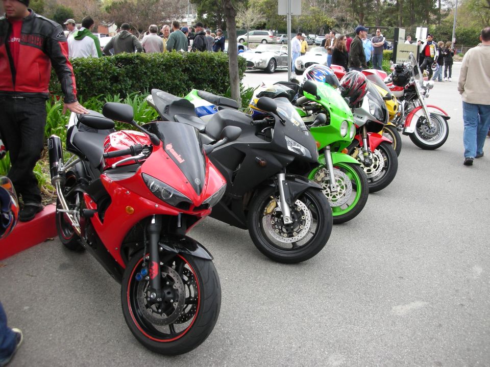 Row of sportbikes including red, green and black models at a meet