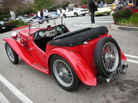 1998 Ford Crown Victoria - Rear-quarter view of a red MG TC roadster with wire wheels and a UK-style plate reading KTF791 at a car show.