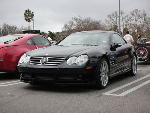 1998 Ford Crown Victoria - Front three-quarter view of a black Mercedes-Benz SL-Class roadster parked among other cars at a show.