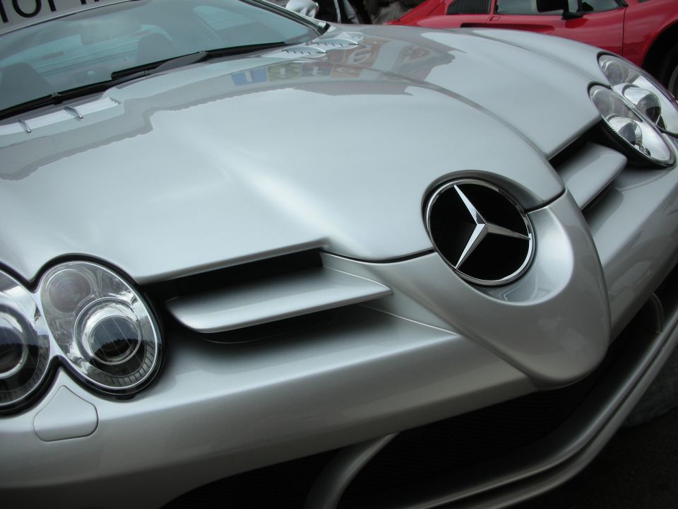Close-up of a silver Mercedes-Benz SLR McLaren nose and large grille star