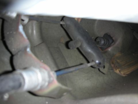 1998 Ford Crown Victoria - close-up underside shot of a vehicle showing an exhaust component, rubber mount bushing and steel mounting brackets.