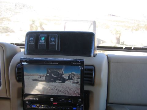 1996 Ford Bronco - The interior features ARB switches for air lockers and compressor, along with a multimedia receiver displaying a Jeep on a trail.