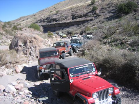 1996 Ford Bronco - A convoy of Jeeps navigates a desert landscape on an off-road adventure.