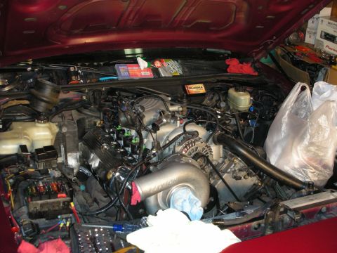 1992 Ford Crown Victoria - Engine bay of a 1992 Ford Crown Victoria undergoing modifications with a turbocharger.