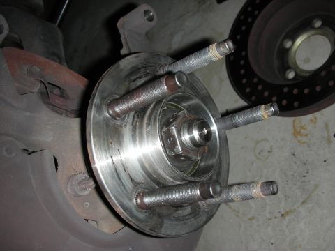 1992 Ford Crown Victoria - A close-up view of a vehicle's wheel hub assembly, showing lug studs and a brake rotor in the background. The parts appear to be from a rea…