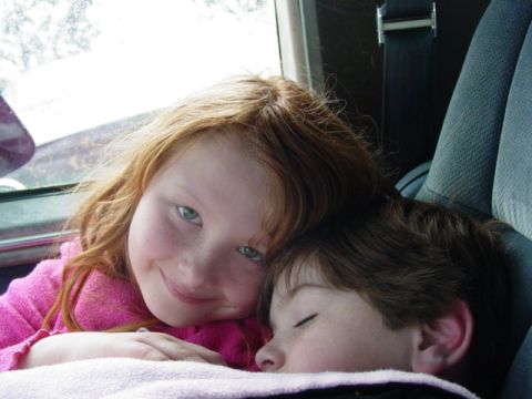 1986 Ford Bronco - Children resting inside a vehicle during a trip.