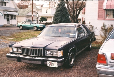 1984 Mercury Grand Marquis - This 1984 Mercury Grand Marquis is seen from the front, its distinctive chrome grille and a custom license plate.