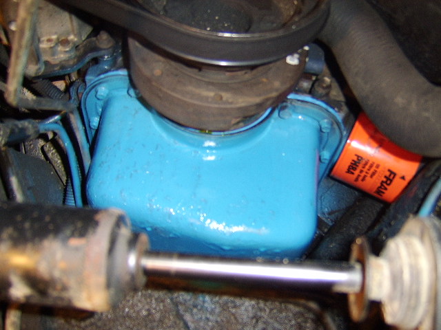 Blue-painted engine block with orange FRAM oil filter in a grimy engine bay