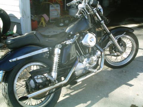 1979 Ford Bronco - Side view of a Harley-Davidson Sportster motorcycle with a black seat and fuel tank.
