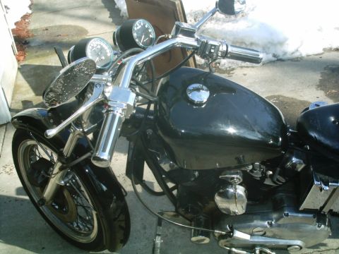 1979 Ford Bronco - Close-up view of a black motorcycle's fuel tank and handlebars, showing chrome accents and gauges.