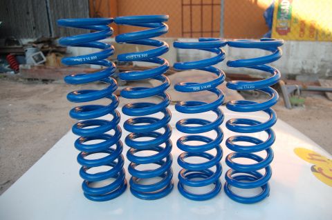1992 Ford Explorer - Four blue coil springs are displayed, with visible text indicating part numbers and spring rate information.