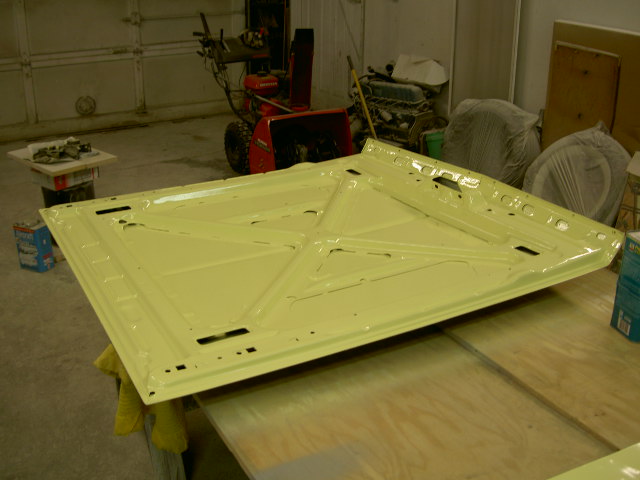 yellow car hood on workbench
