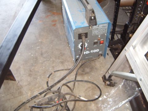 1988 Ford Bronco - A blue IG-100 welding machine is shown with its cables and a ladder in the background.