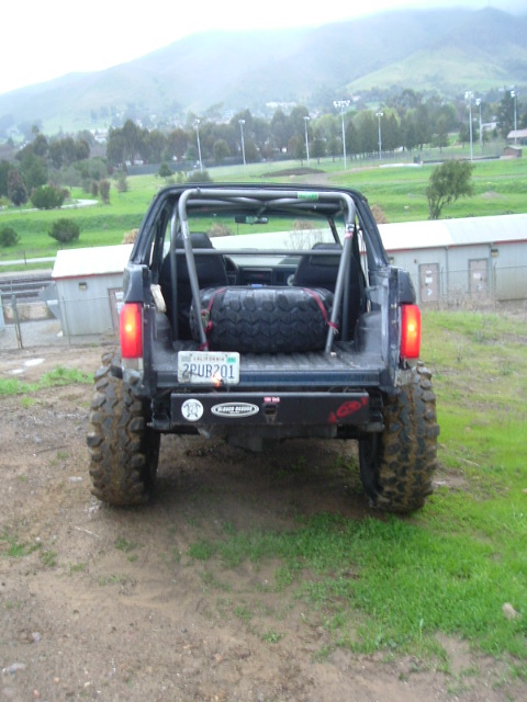 1989 Ford Bronco - This 1989 Ford Bronco is shown from the rear, a spare tire mounted inside and a custom roll cage.