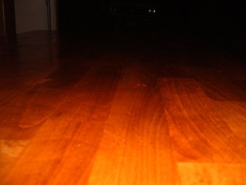 1988 Ford Bronco - Wooden floor with distant headlights visible in the dark.