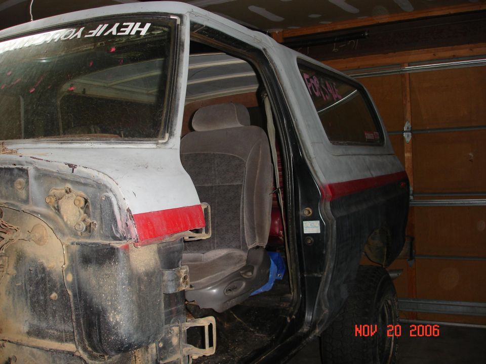 1978 Ford Bronco interior showing seats and rear quarter panel, with "HEY IF YOU..." sticker on rear window