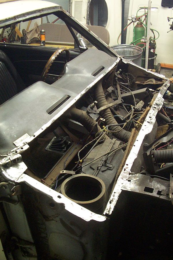 1968 Ford Mustang interior showing dashboard removed, exposed wiring, and steering wheel