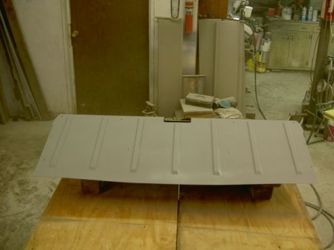 1967 Ford Ranchero - A vehicle tailgate is prepped for paint in a workshop setting.