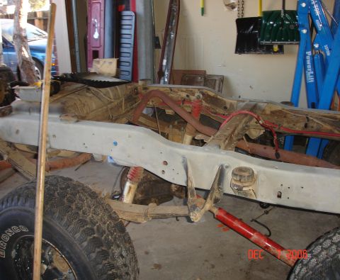 1978 Ford Bronco - Frame and suspension components are visible, with a tire that has 'BRONCO' written on it.