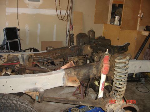 1978 Ford Bronco - Frame and suspension components are visible in this garage setting, possibly during a build or repair.