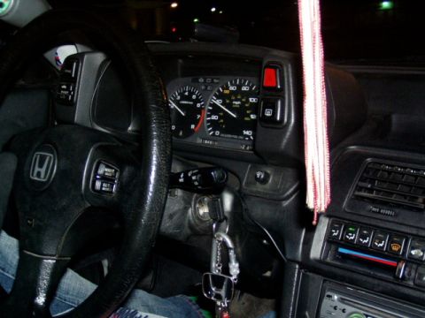 1993 Ford Probe - The interior of a Honda shows the steering wheel, dashboard, and center console with air conditioning controls.