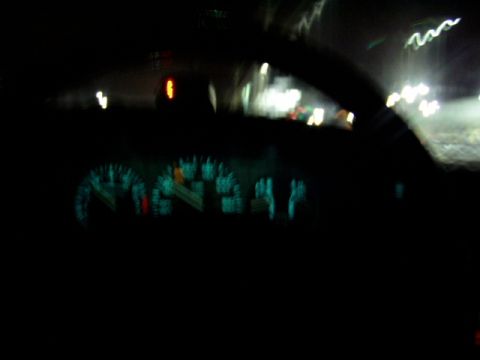 1993 Ford Probe - Interior view of illuminated dashboard gauges at night, with blurry lights visible outside.