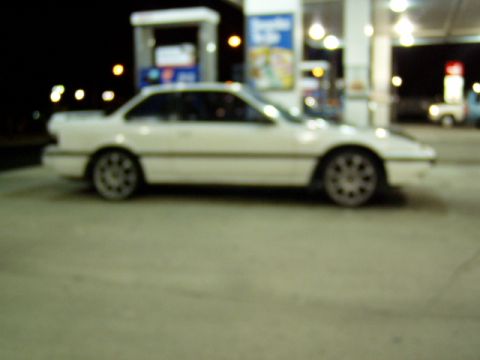 1993 Ford Probe - White 1993 Ford Probe coupe seen at a gas station after dark.