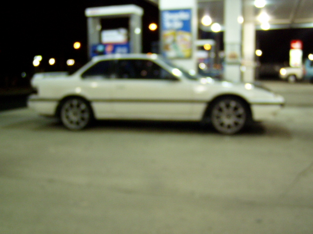 1993 Ford Probe coupe parked at a gas station at night