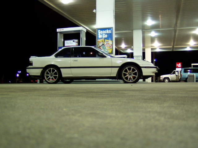 White 1990s Honda Prelude coupe parked at a gas station at night
