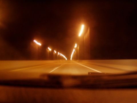 1993 Ford Probe - Driving through a tunnel at night, the road ahead is illuminated by rows of lights.