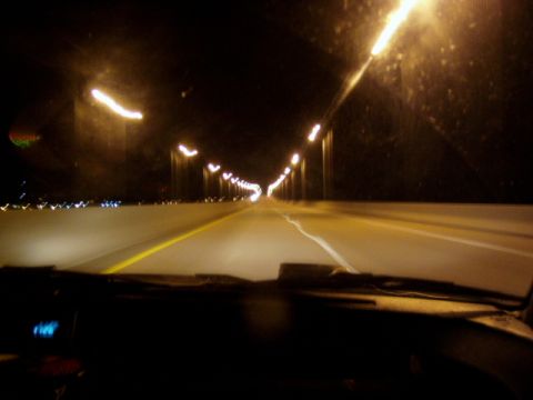 1993 Ford Probe - Driving on a highway at night, illuminated by streetlights.