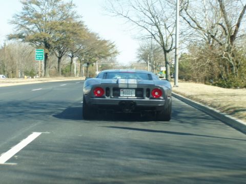 1993 Ford Probe - Rear view of a gray Ford GT sports car driving on a road.