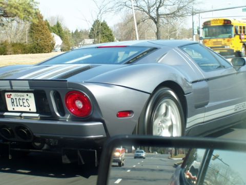 1993 Ford Probe - A silver Ford GT is seen driving on the road, with a yellow school bus in the background.