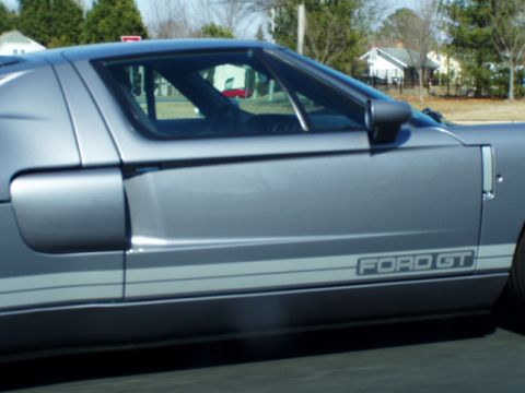 1993 Ford Probe - Side view of a silver Ford GT showing the door panel and stripe detail.
