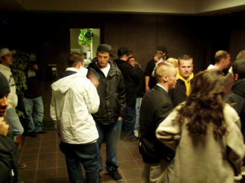 1993 Ford Probe - A group of people are standing around indoors, possibly at an event or gathering.