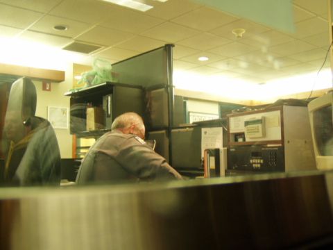 1993 Ford Probe - An office scene with individuals working at their desks, surrounded by office equipment and partitions.
