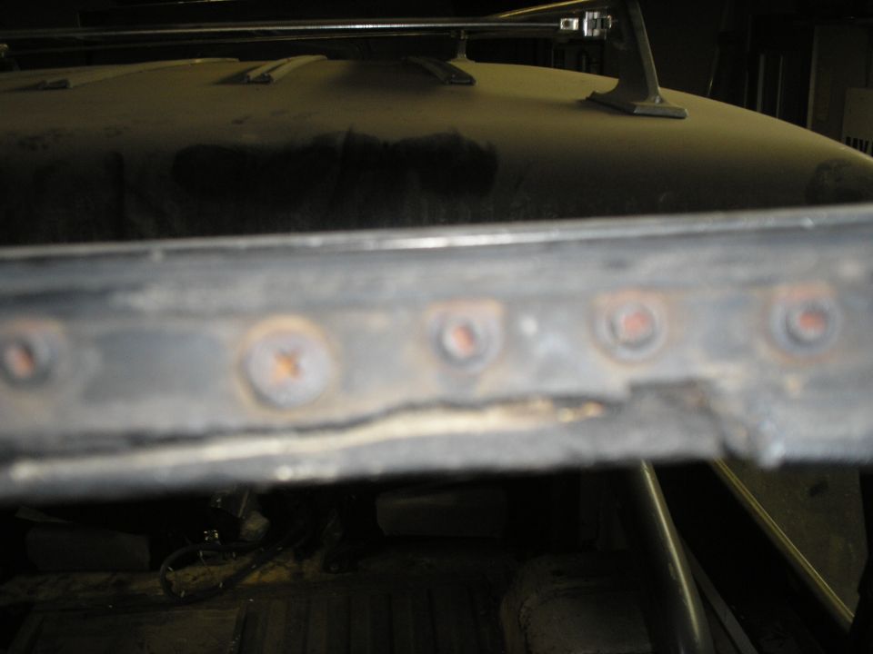 Close-up of rusty mounting points on a vehicle's roof rack