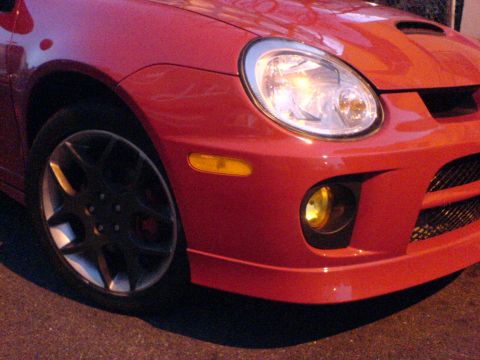2005 Dodge SRT-4 - Front view of a red 2005 Dodge SRT-4, highlighting its distinctive bumper and wheel design.