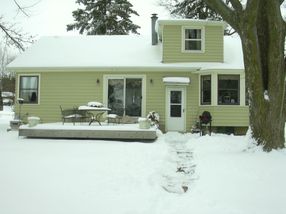 House with snow-covered deck and yard